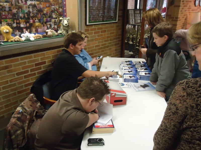 photo of Brett signing the new book
